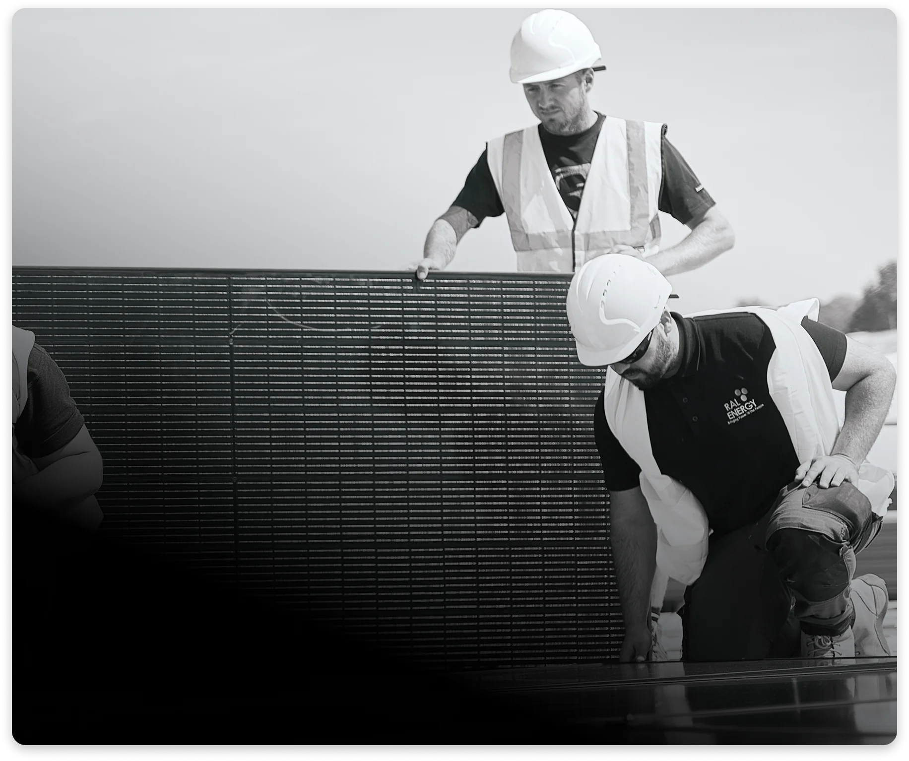 Solar installers fitting panels on a rooftop