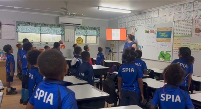 Students in SPIA uniforms taking part in a classroom activity